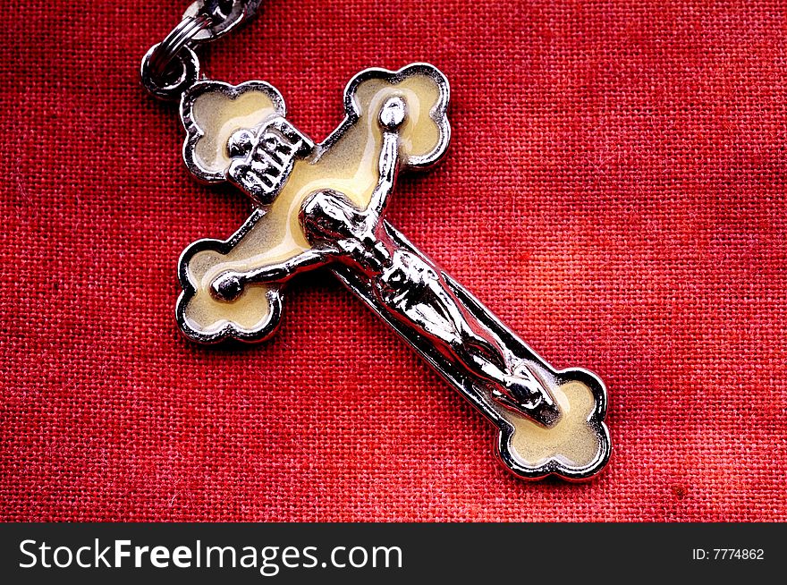 Rosary in macro over red cloth background. Rosary in macro over red cloth background