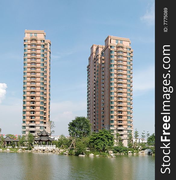 There are two upscale apartment block by the lakeside,beautiful reflection in the calm lake water suface.