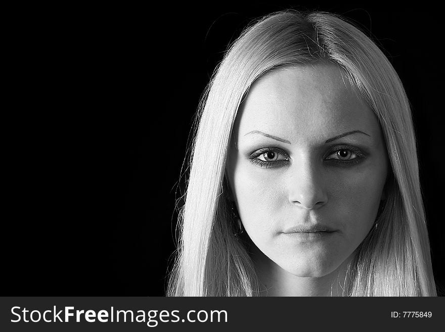 Portrait of the young beautiful blonde on a black background