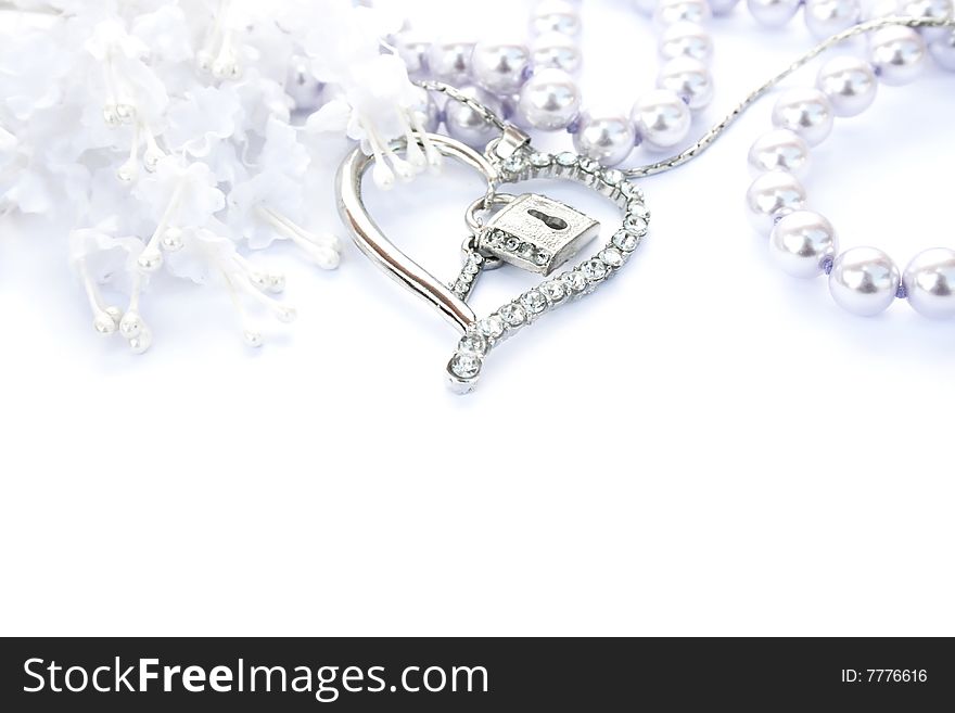Silver heart with key,lock,pearls and flowers on white background.