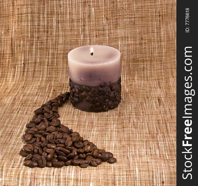 Coffee candle close-up isolated on a beige sacking