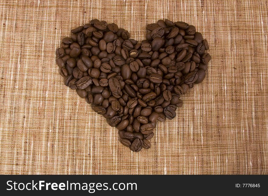 Coffee beans close-up isolated on a beige sacking