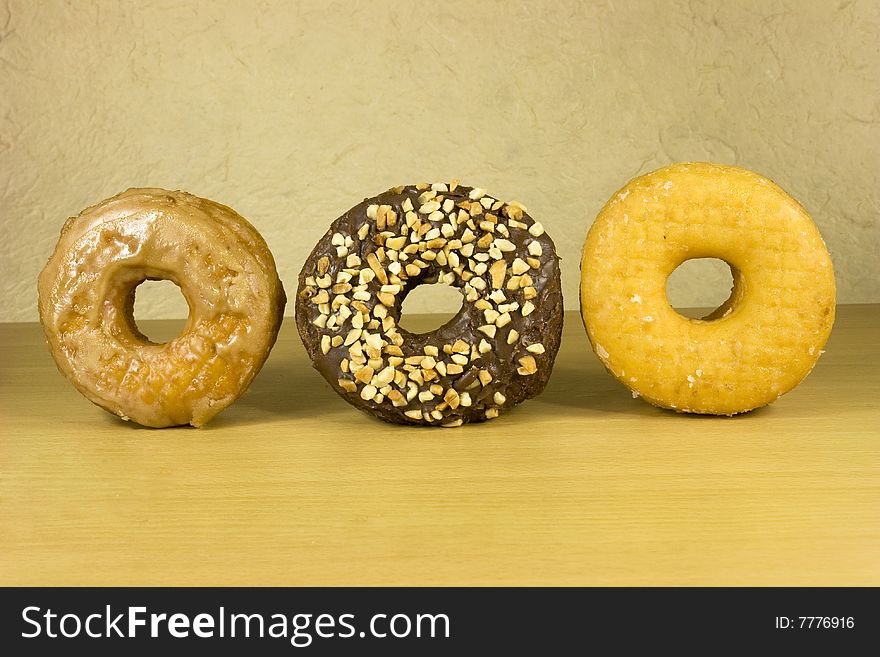 Three fresh donuts on surface