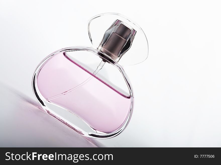 Beautiful transparent bottle of pink perfume