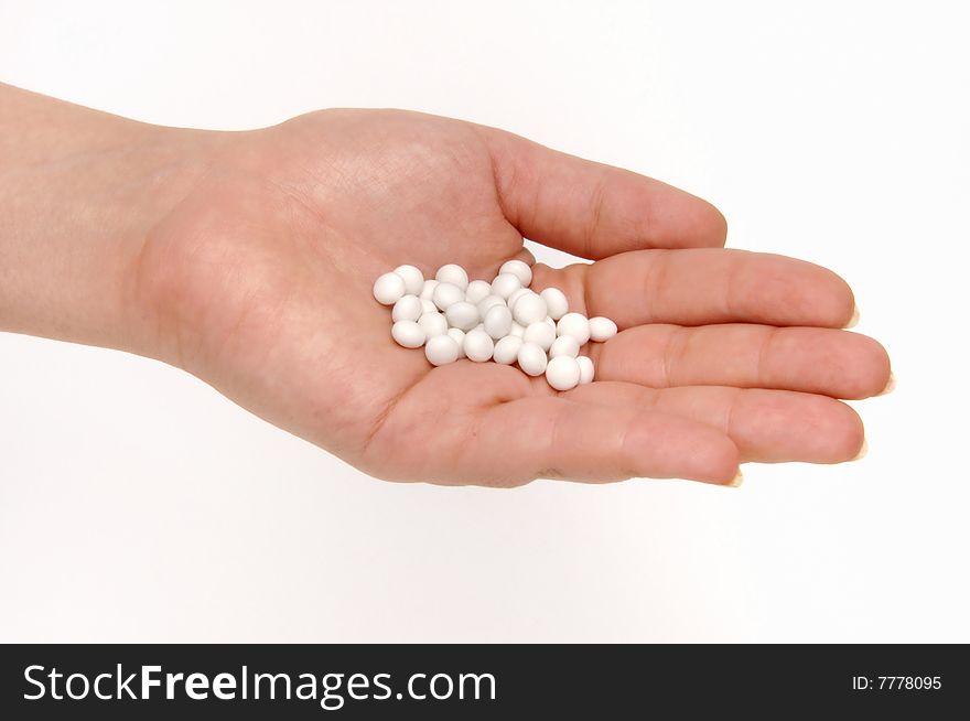 Medicine pills on hand at white background