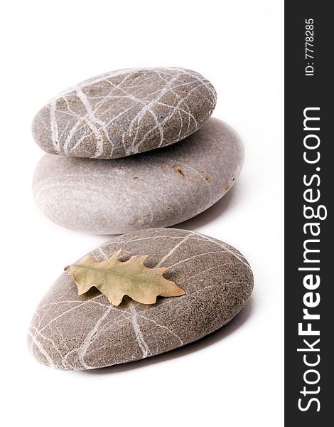 Stones with dry leaf on a white backgroun
