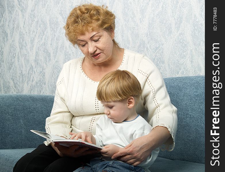 Portrait of the grandmother with the grandson in house conditions