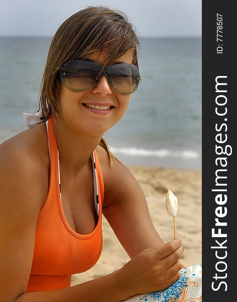 Girl eating ice-cream in the beach. Girl eating ice-cream in the beach