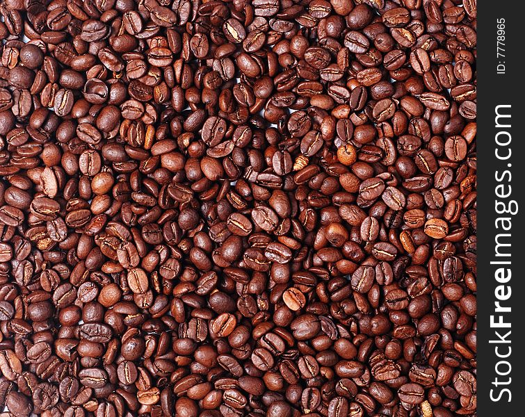 Heap of burnt brown arabica coffee beans