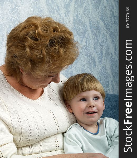 Portrait of the grandmother with the grandson in house conditions