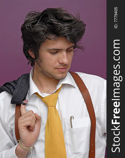 Young man posing against a purple background