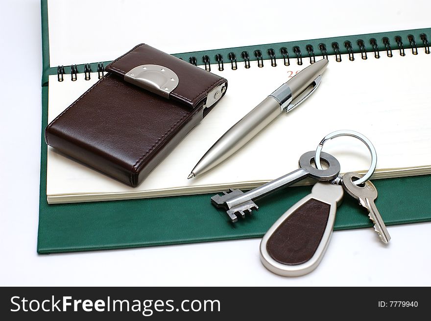 Diary,handle and keys on a white background. Diary,handle and keys on a white background