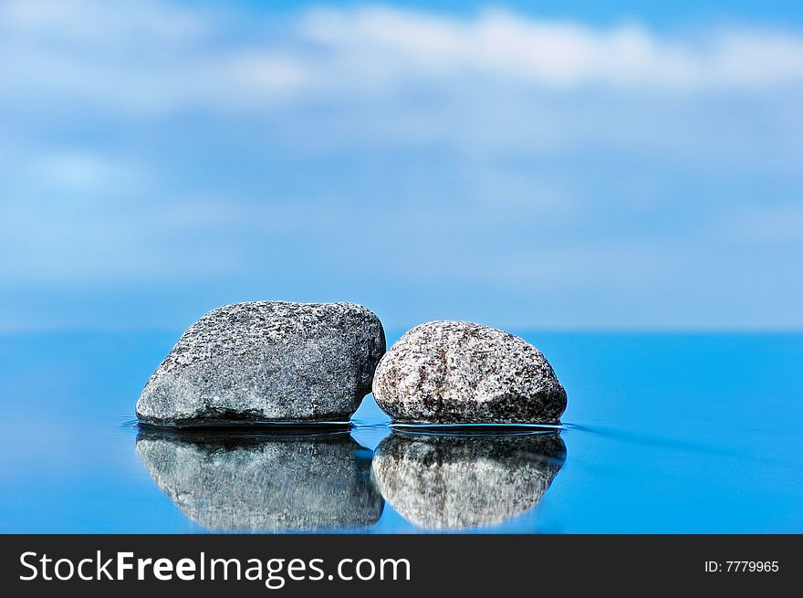 Stones on a smooth surface against the dark blue sky. Stones on a smooth surface against the dark blue sky