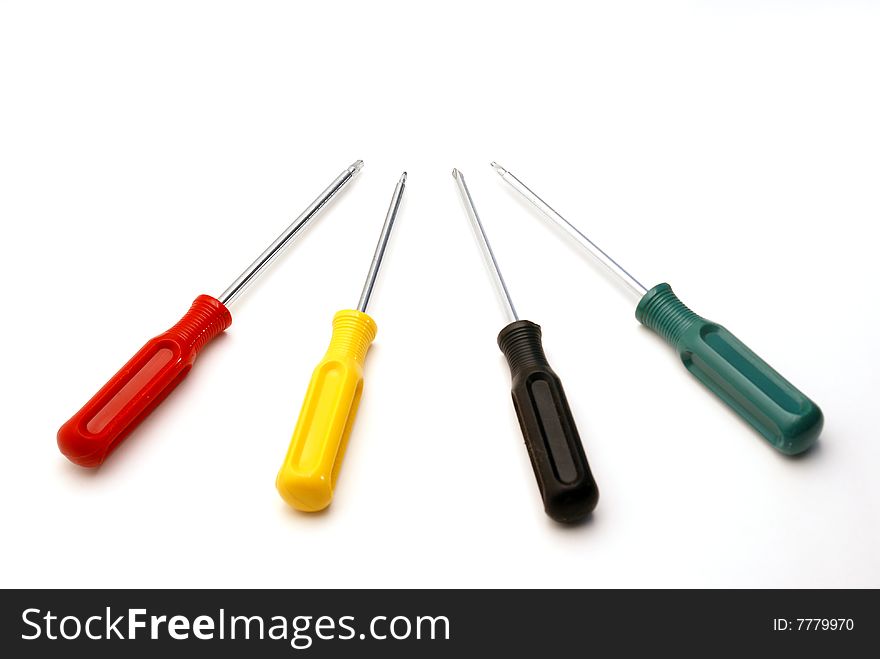 Four colored screwdrivers are isolated over white.