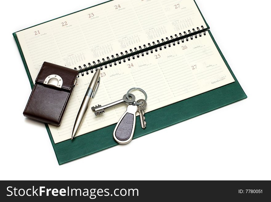 Diary, handle and keys on a white background