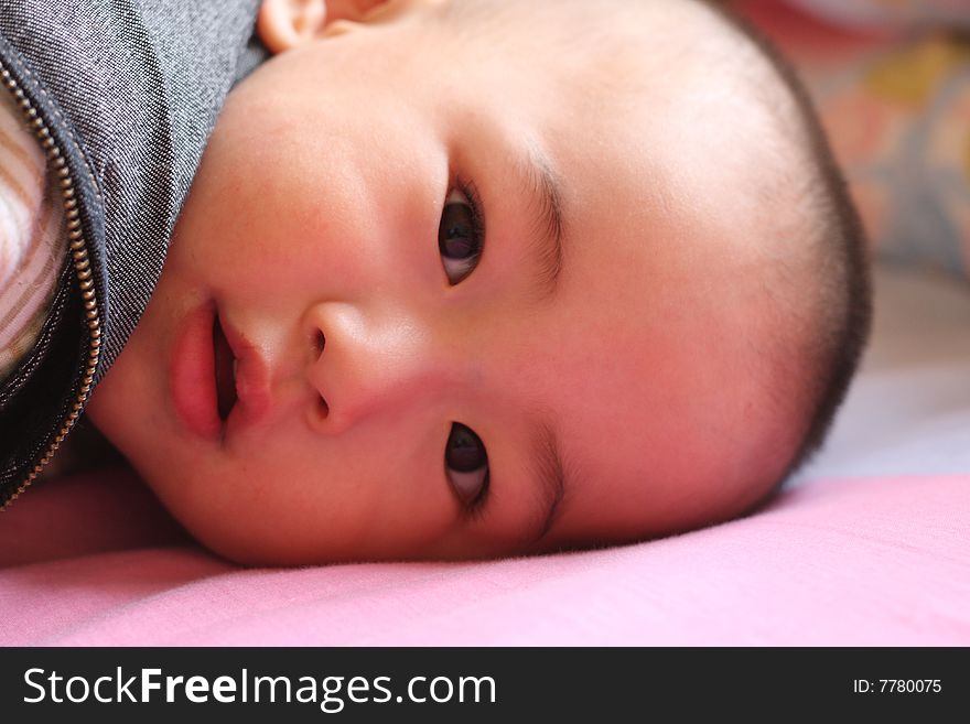 Cute, happy laughing baby boy in the morning.