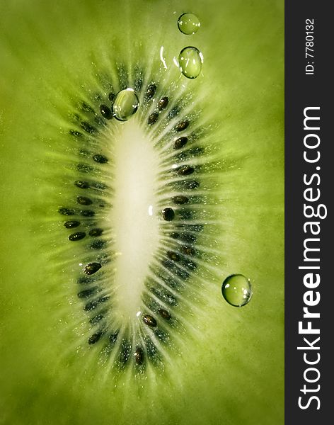 Macro of kiwi with water drops background