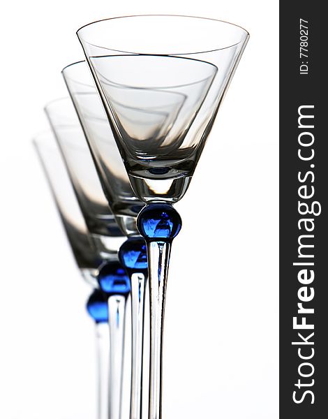 Four blue wineglasses against the white background