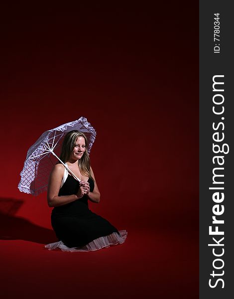 Pretty woman with lace parasol against red background. Pretty woman with lace parasol against red background