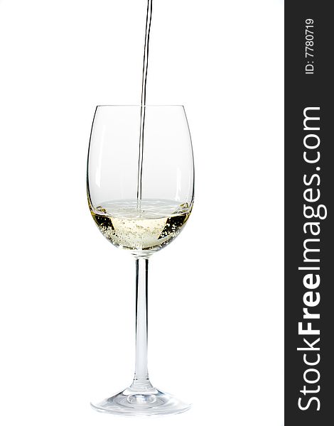 Pouring white wine in a glass over a white background