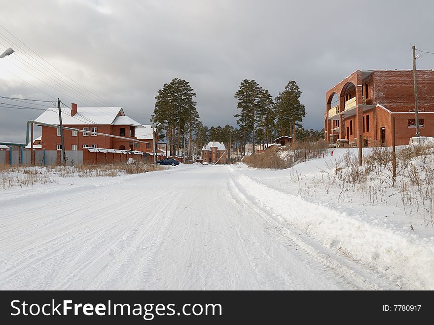 Village street, unfinished house without roof