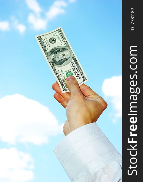 Money in hand  isolated on sky background