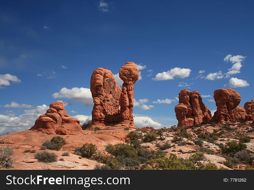 View of the red rock formations in Arches National Park with blue skyï¿½s and clouds