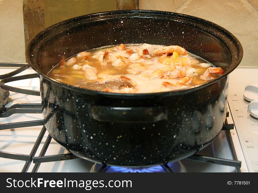 Some shrimp boil in a large pot.