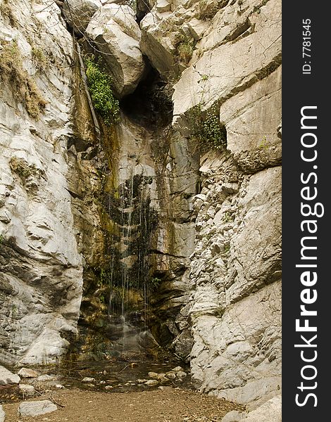 Waterfall,rocks, and boulders in California canyon with pool at base. Waterfall,rocks, and boulders in California canyon with pool at base.