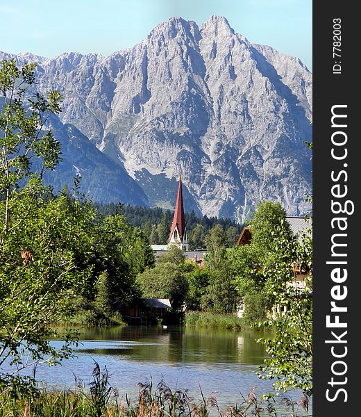 A landscape of tirolean mountain with a little lake and a church. A landscape of tirolean mountain with a little lake and a church.