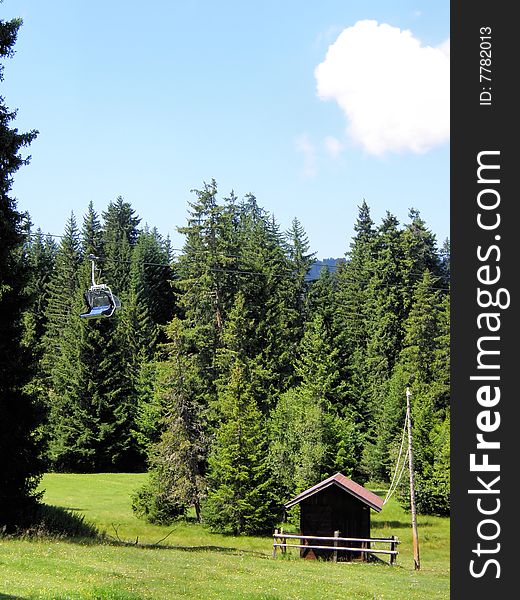 A landscape of tirolean mountain with a little hoiuse and a chairlift. A landscape of tirolean mountain with a little hoiuse and a chairlift.