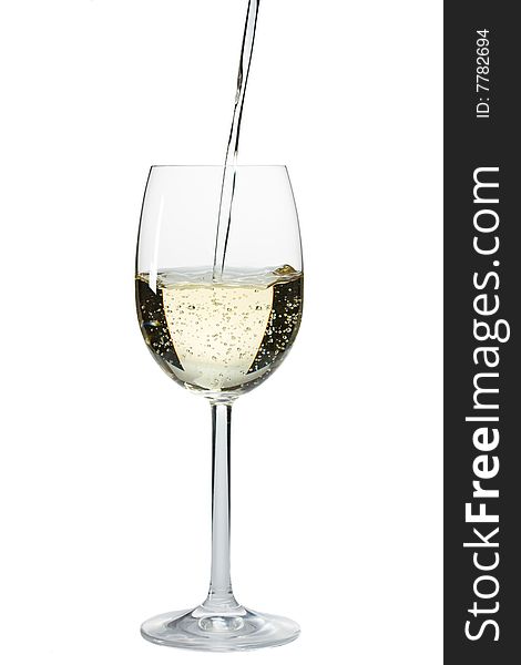 Pouring white wine in a glass over a white background