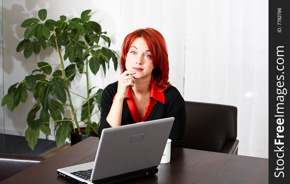 Young pretty caucasian businesswoman in the office. Young pretty caucasian businesswoman in the office