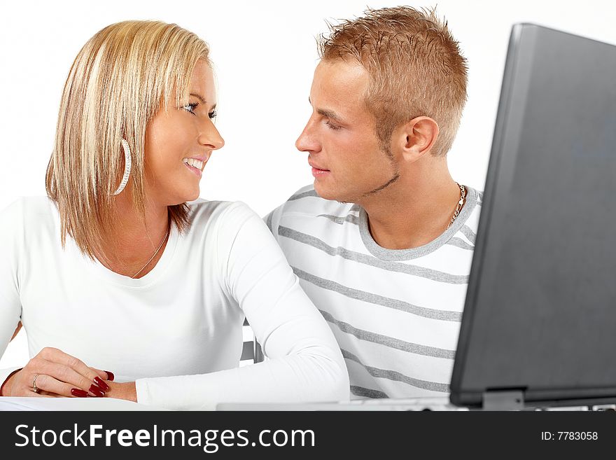 Portrait of a happy couple working with laptop in home or office. Portrait of a happy couple working with laptop in home or office