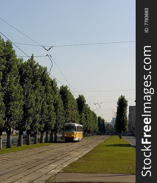 A tram railroad view with a vehicle on it. A tram railroad view with a vehicle on it