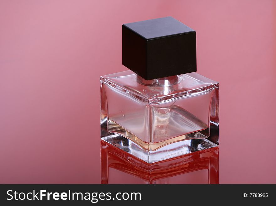 Bottle of a perfume for women on a red background