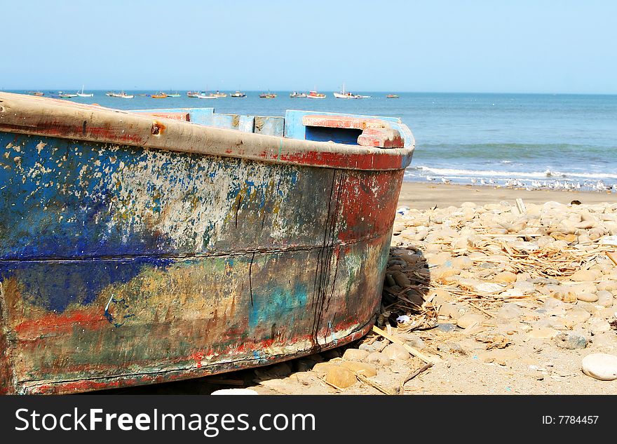 A colorful wooden fishing boat on the beach in Peru. A colorful wooden fishing boat on the beach in Peru