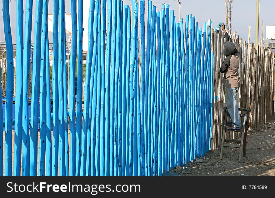 Spray painting a wooden fence in Peru. Spray painting a wooden fence in Peru