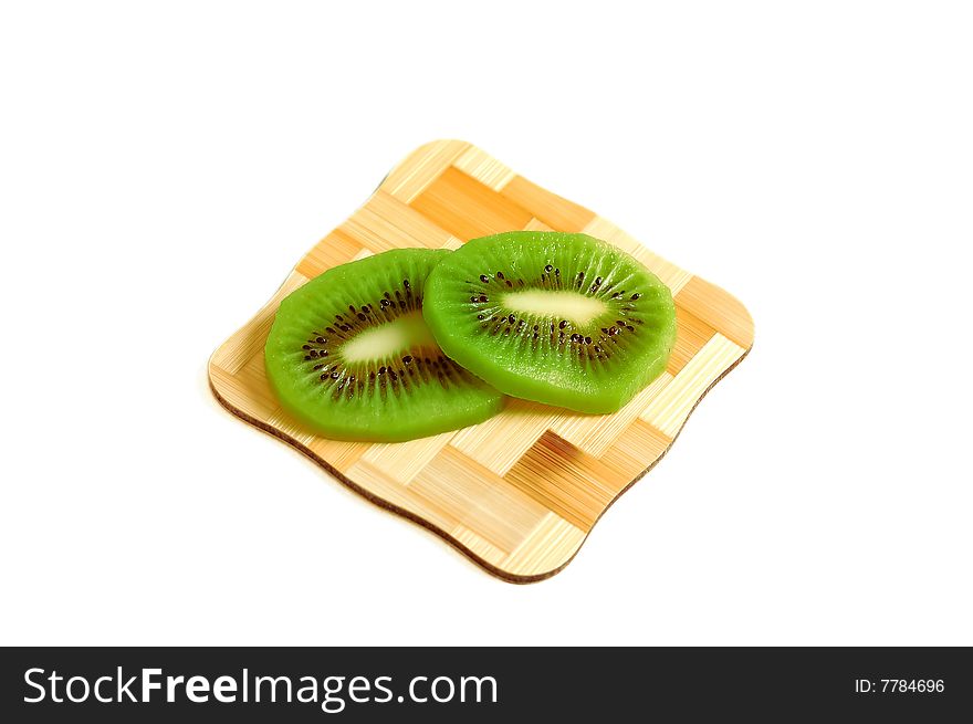 Kiwi on bamboo placemat on white