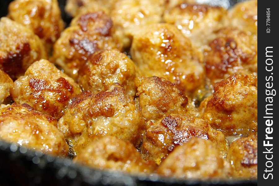 Some delicious meet-balls made from fresh sausage frying in the pan. Some delicious meet-balls made from fresh sausage frying in the pan