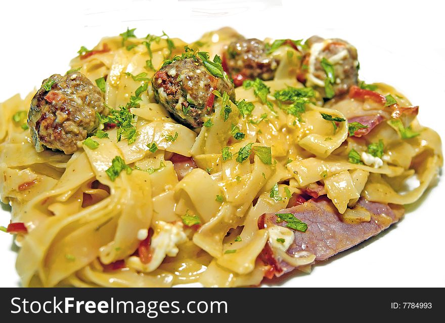 Meet-balls pasta with plenty of fried bacon and parsley