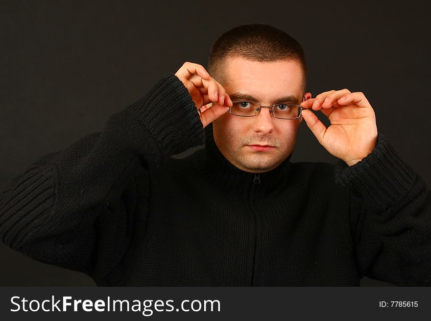 Young relaxed casual man on the dark background. Face portrait. Young relaxed casual man on the dark background. Face portrait