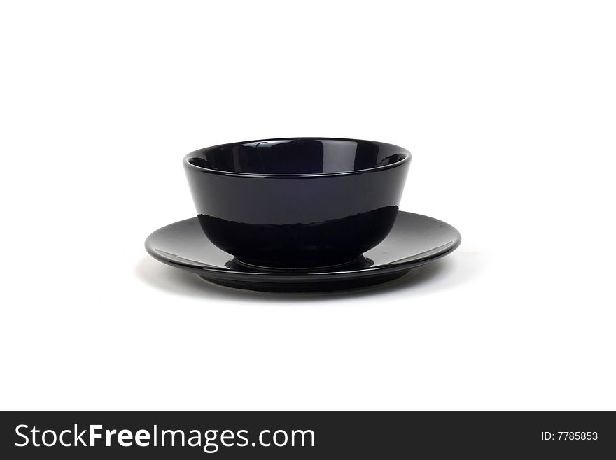 Glossy black bowl on a matching plate against white bckgnd. Glossy black bowl on a matching plate against white bckgnd