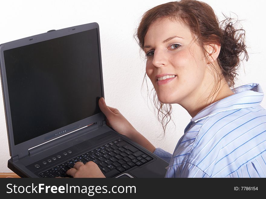 A young woman at home with her laptop. A young woman at home with her laptop.