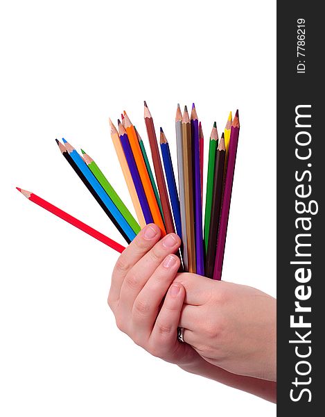 Thick colored pencils in a hand against a white background. Thick colored pencils in a hand against a white background