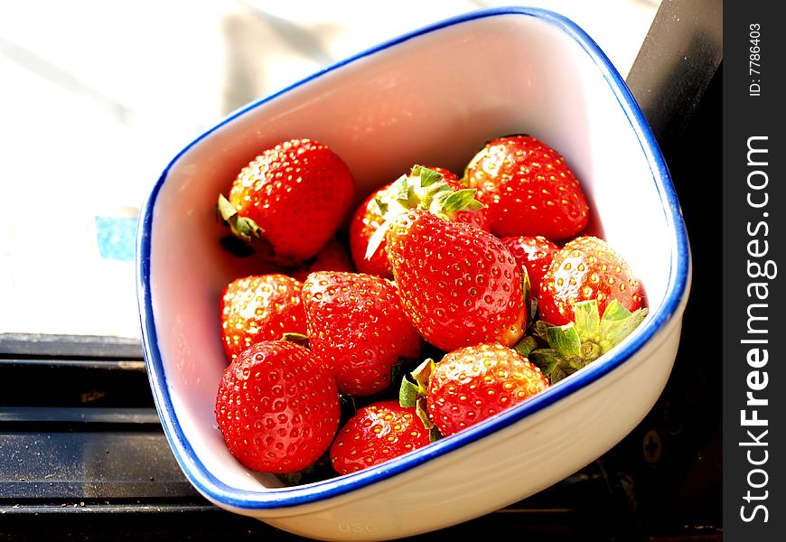 Red strawberries on bowl