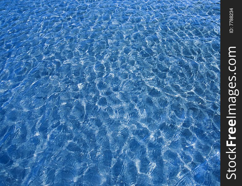 Blue water background with sea sand