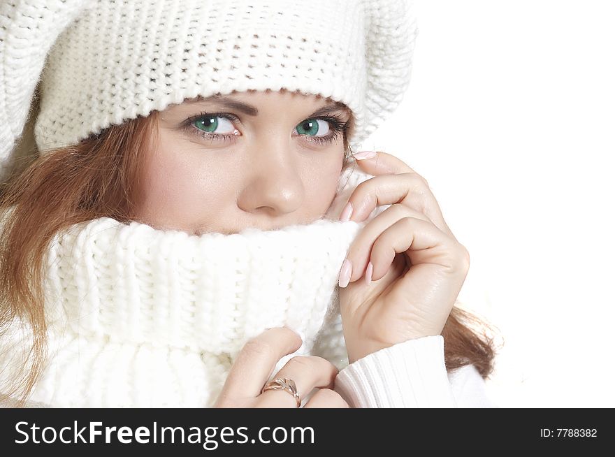 Beautiful girl in a sweater touches by hands face. Beautiful girl in a sweater touches by hands face