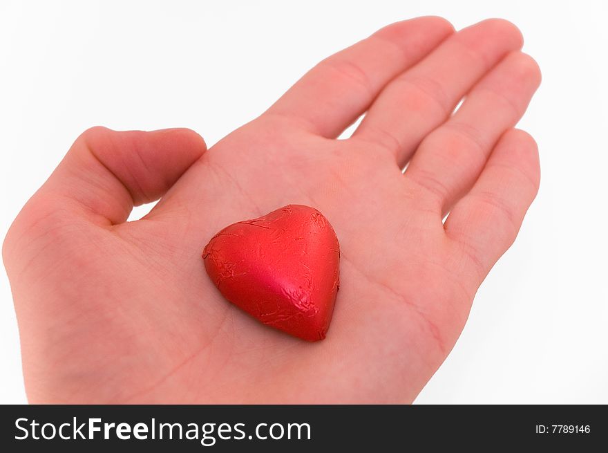 Red heart being offered on hand. Red heart being offered on hand.