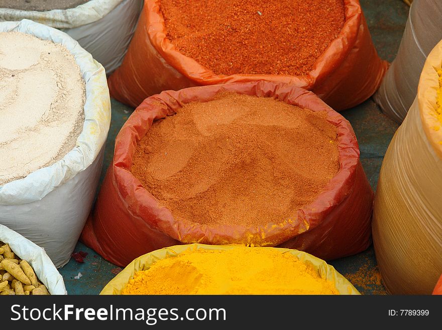 A supply of colorful, powdered Indian spices for the kitchen.